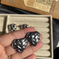 Heart knotted silver earrings